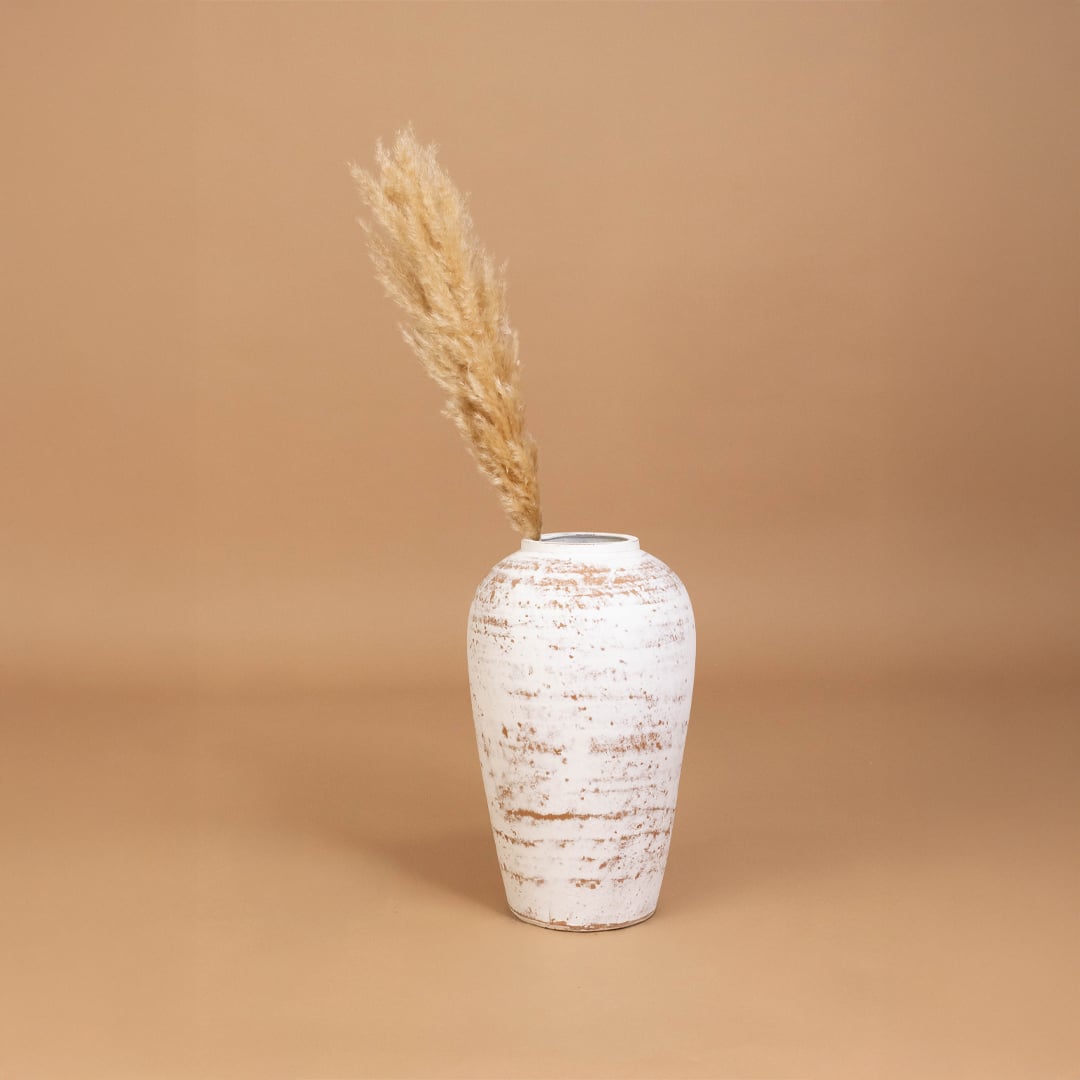 White rustic tall vase placed in a curated home setting enhancing consoles shelves and living spaces with natural artistic decorative appeal.