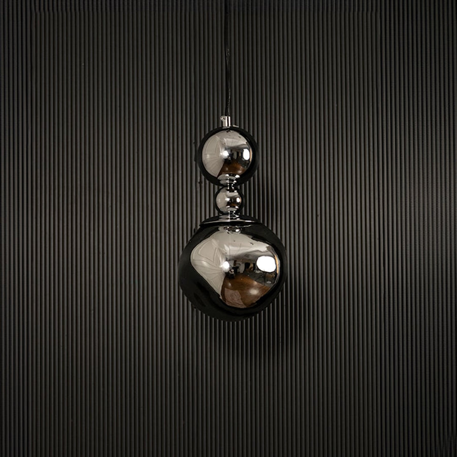 Reflective chrome pendant light with silver finish displayed on dark background with lights off highlighting texture.