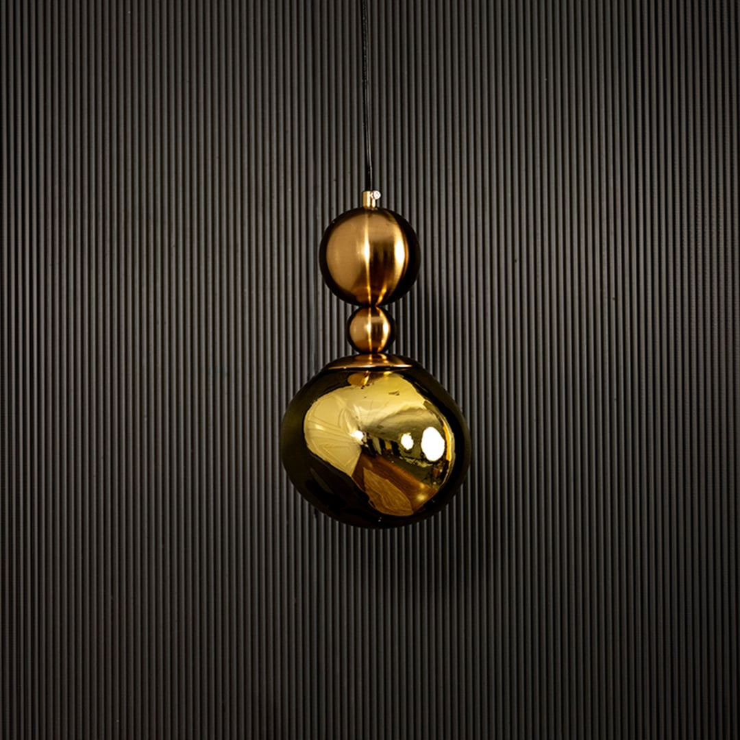 Golden pendant light displayed on dark background with light off showcasing elegant and luxurious metal finish.