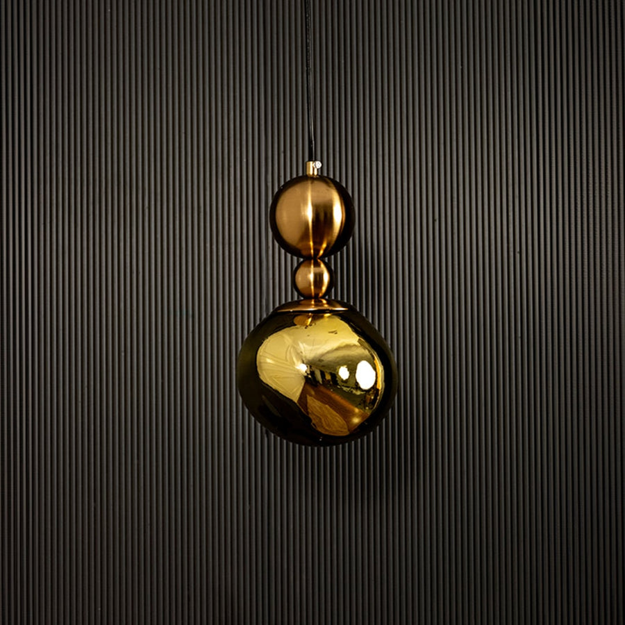 Golden pendant light displayed on dark background with light off showcasing elegant and luxurious metal finish.