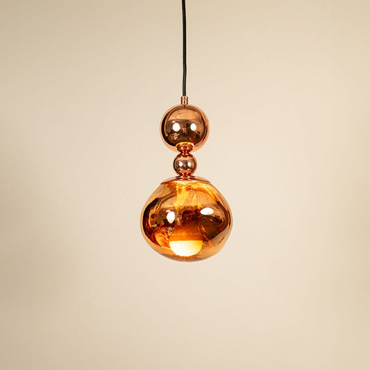 Copper metallic pendant light glowing on white background showcasing elegant design for modern home lighting.