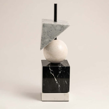 Modern marble geometric decor piece with cube sphere and triangle shapes displayed on plain white background.