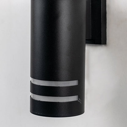 Closeup of black cylindrical wall light showing frosted dual-ring detailing and elegant metal craftsmanship.