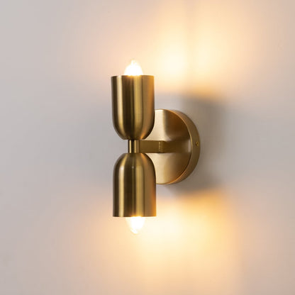 Gold wall sconce glowing warmly against white background ideal for bedroom or hallway lighting with modern appeal.