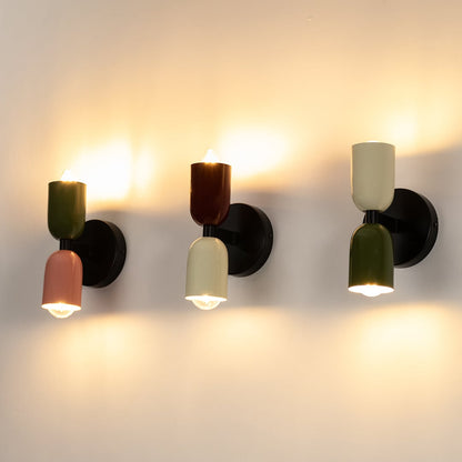 Collection of dual tone red and cream wall sconces arranged together showcasing stylish modern home lighting.