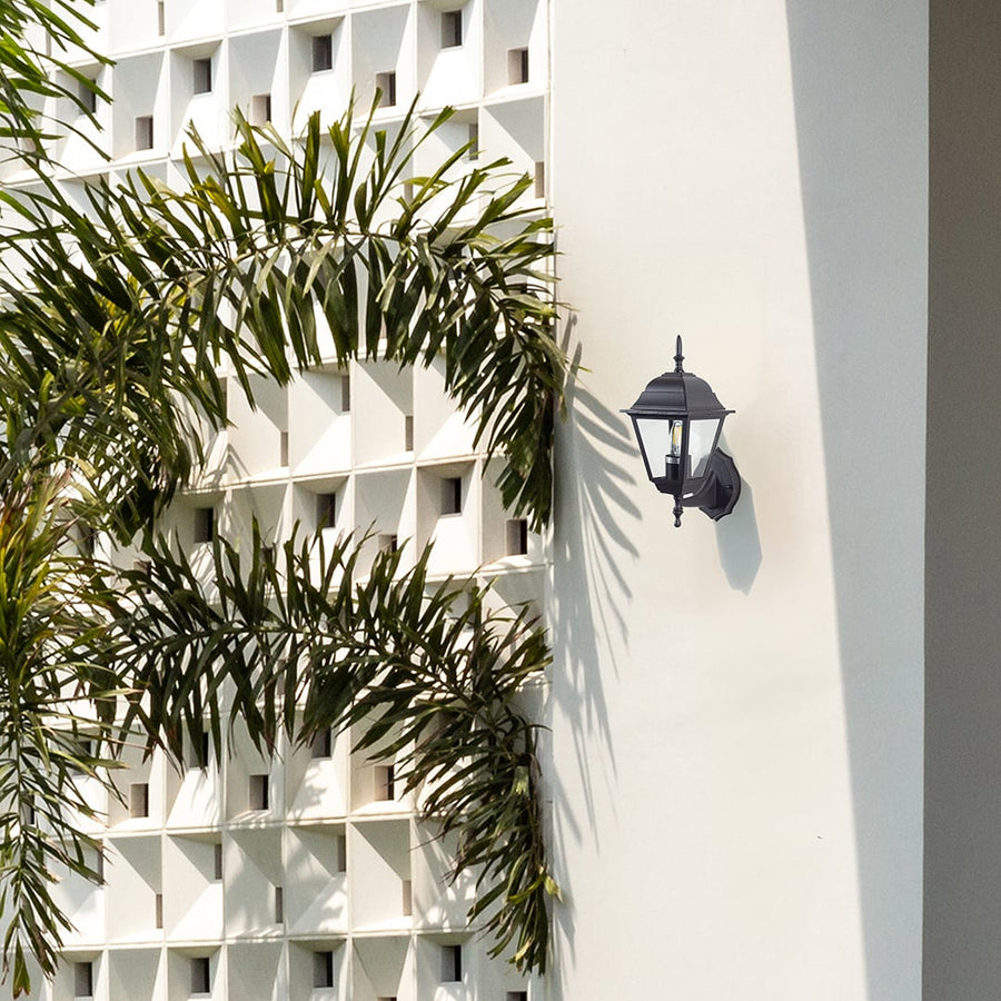 Black metal outdoor wall light lifestyle image on modern exterior wall for stylish patio lighting decor.
