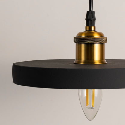 Black ring pendant light featuring a minimalist circular frame with brass socket and suspended cable shown with light off.