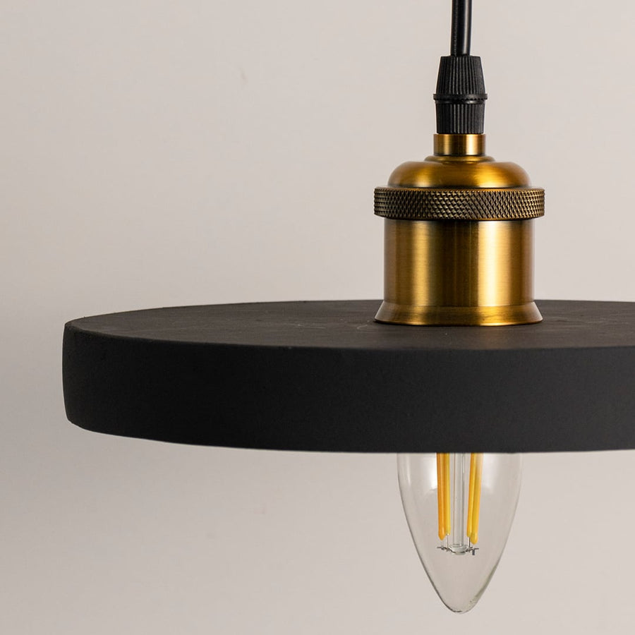 Black ring pendant light featuring a minimalist circular frame with brass socket and suspended cable shown with light off.