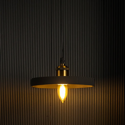Black ring pendant light emitting a soft warm glow highlighting its sleek circular silhouette against a dark backdrop.