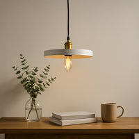 Black metal pendant light above wooden table adding modern elegance and warm ambiance.