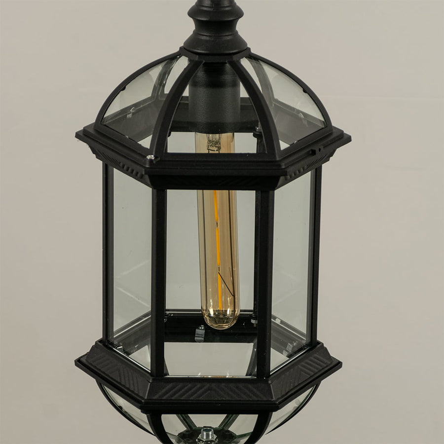 Detailed closeup view of antique brass metal finish and texture of frosted glass panels on this classic outdoor hanging lantern.