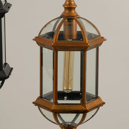 Macro shot showing the sturdy chain suspension and top finial loop of the black metal outdoor pendant light fixture for secure hanging.