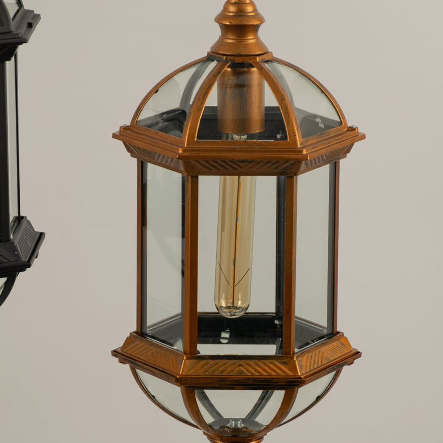 Macro shot showing the sturdy chain suspension and top finial loop of the black metal outdoor pendant light fixture for secure hanging.