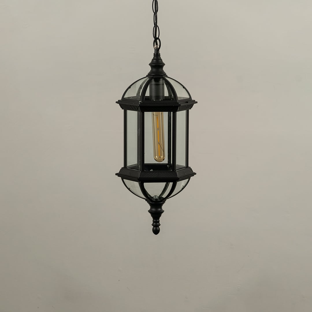 Unlit black metal garden hanging light fixture with chain and frosted glass panels isolated against a plain white background.