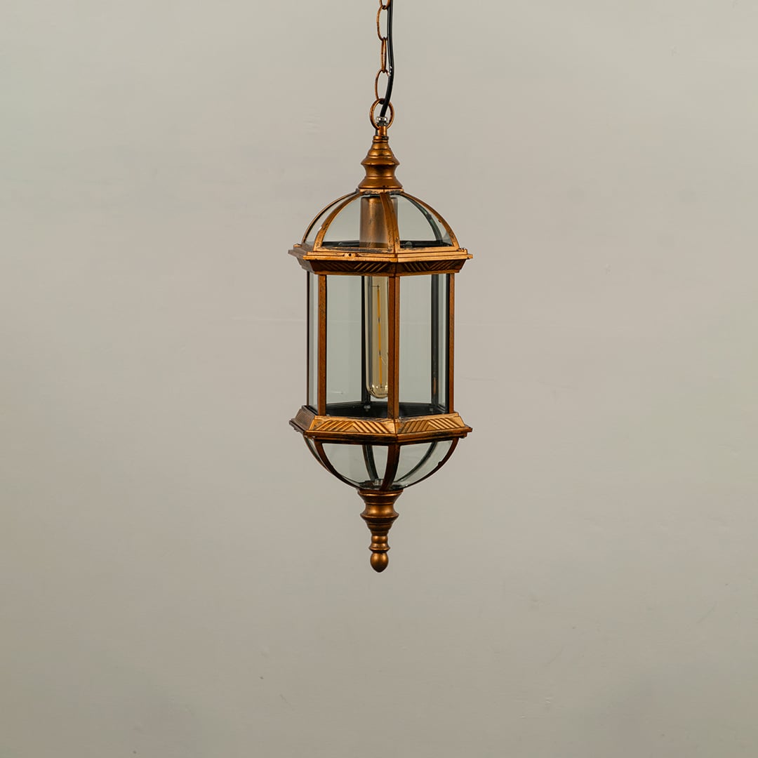 Black metal outdoor hanging light fixture with clear glass panels and elongated hexagonal shape isolated against a plain background.