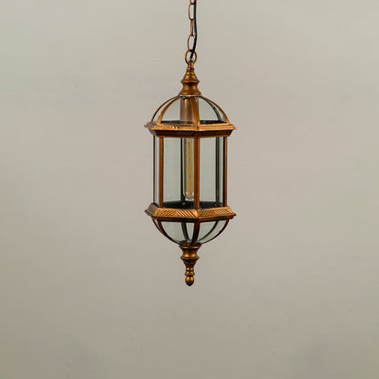 Black metal outdoor hanging light fixture with clear glass panels and elongated hexagonal shape isolated against a plain background.