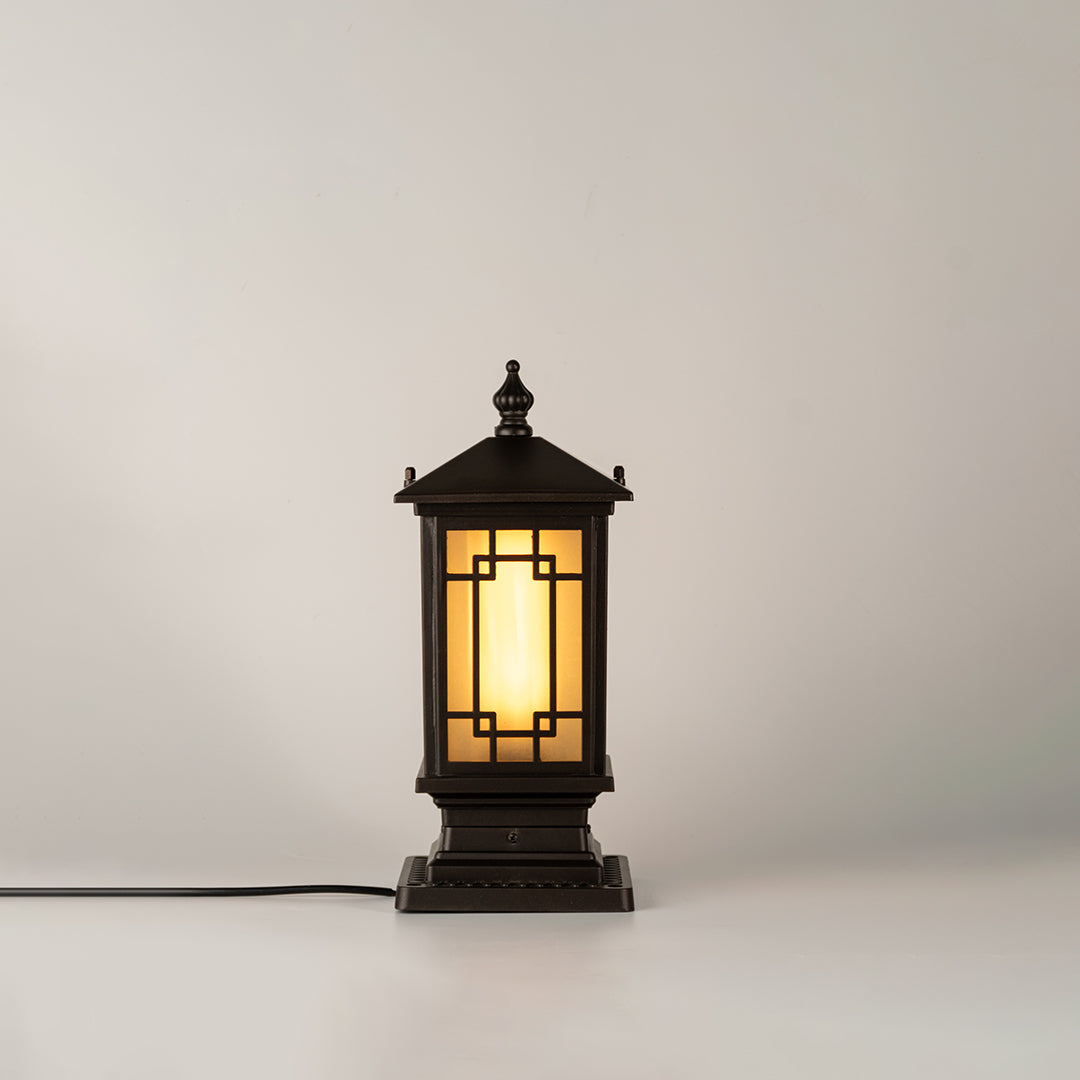 Vintage black outdoor gate light with glowing glass panels for luxury exterior decor styling use.