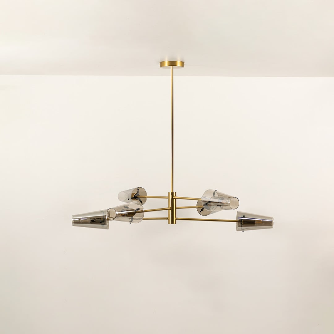 Clear glass shade chandelier with gold metal frame designed for elegant modern ceiling lighting in contemporary interiors.