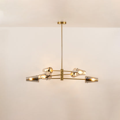 Clear glass chandelier with gold metal frame and illuminated bulbs creating warm contemporary ceiling lighting indoors.