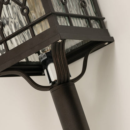 Zoomed view of black metal spike lantern capturing decorative glass patterns and classic lantern style ideal for outdoor landscapes.