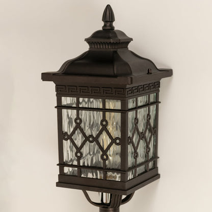 Closeup of black metal spike lantern showing patterned glass and decorative top finial suitable for elegant garden and pathway lighting.