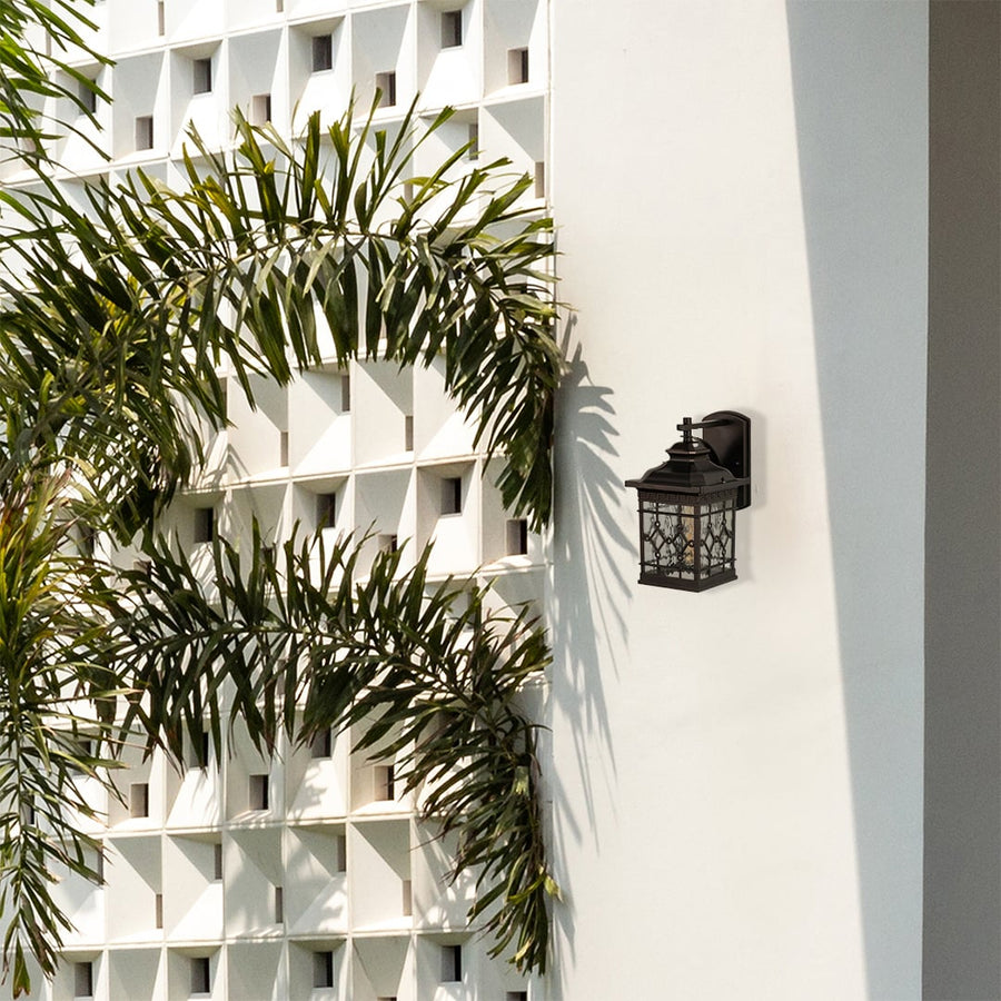 Outdoor lantern mounted on a wall in a clean setting showing its warm glow and vintage design appeal.