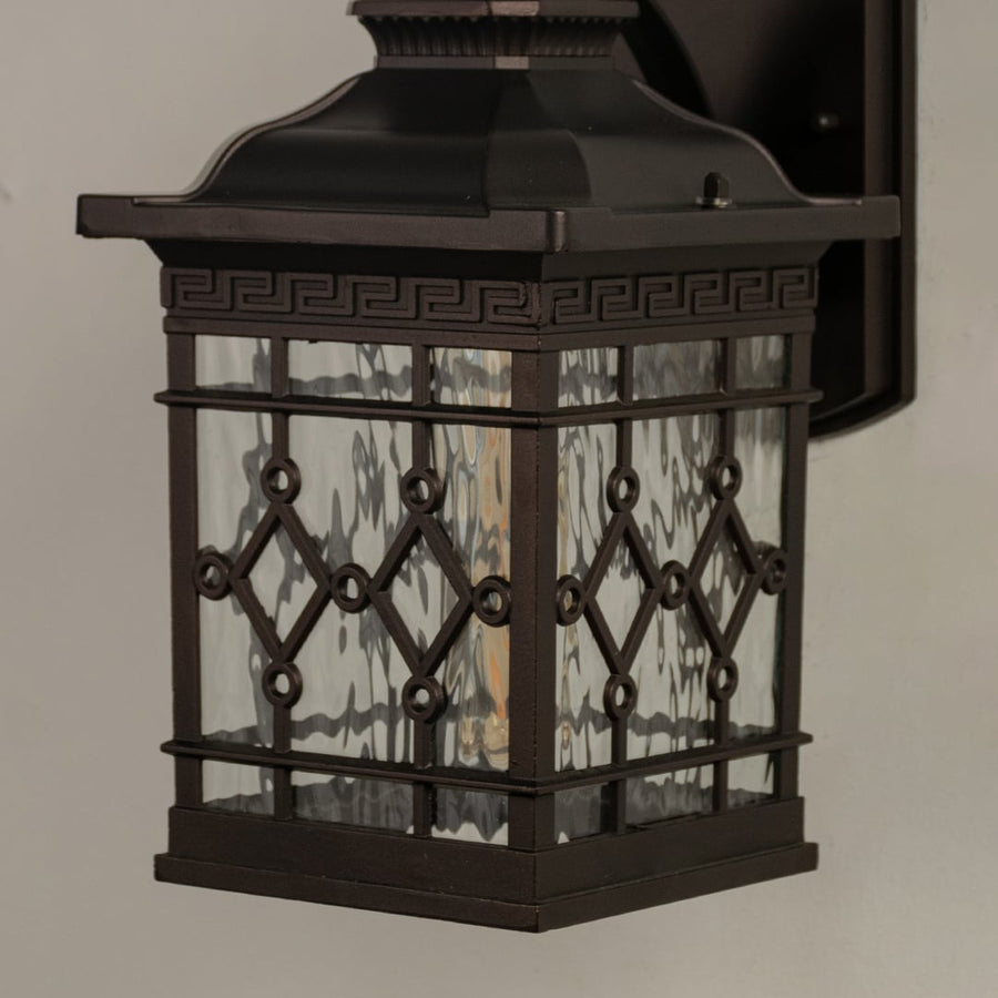 Close view of the outdoor wall lantern showcasing the detailed glass texture and elegant metal craftsmanship.
