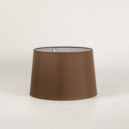 Brown lamp shade shown in close up view on plain background for modern decorative lighting décor.