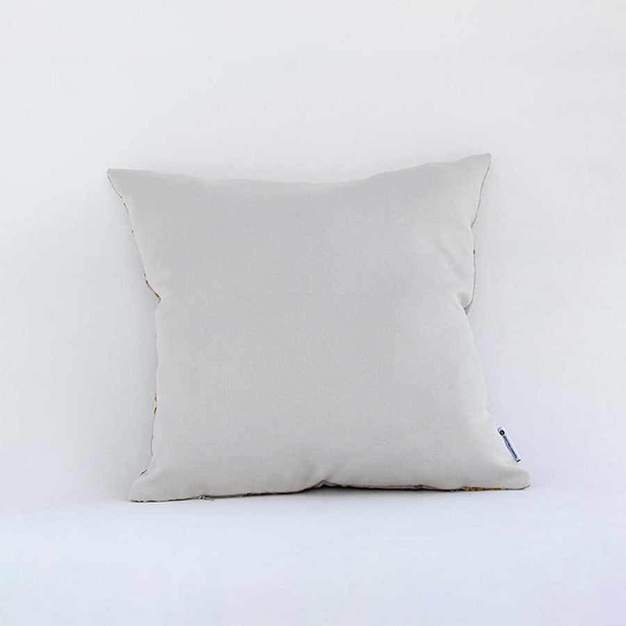 Side view of the floral embroidered cushion showcasing its filled shape and elegant stitched pattern.