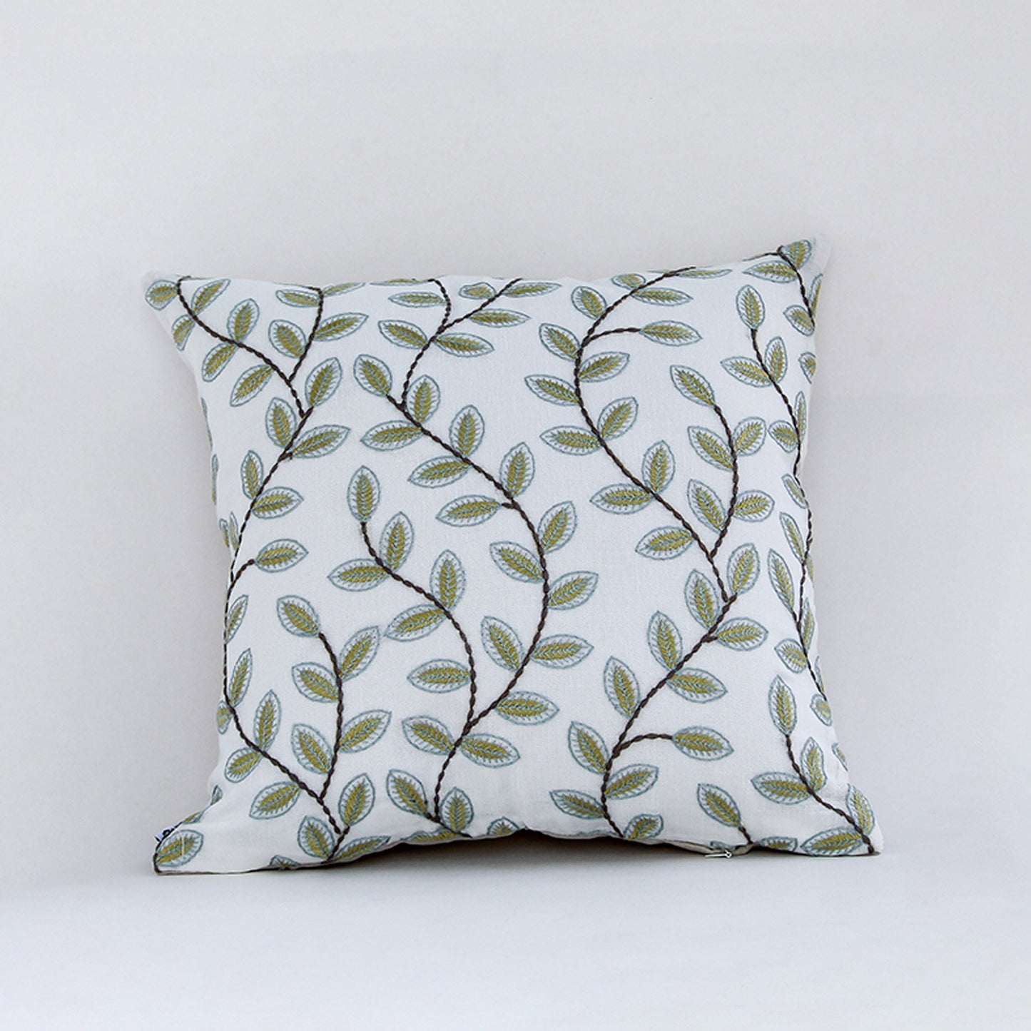 White cotton cushion cover with green botanical leaf print for sofa bedroom seating and fresh modern home decor styling.