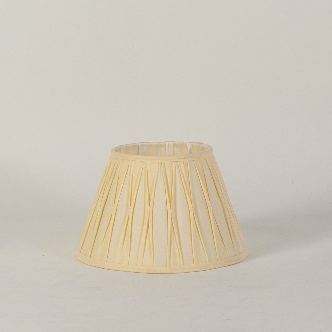 Minimal fabric lampshade in beige finish for table or floor lamp soft lighting and decor placement white background.