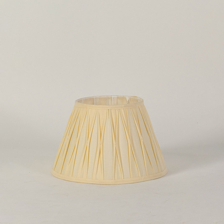 Minimal fabric lampshade in beige finish for table or floor lamp soft lighting and decor placement white background.