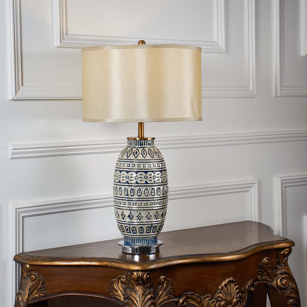 Blue and white patterned ceramic table lamp with fabric shade designed for elegant traditional decor and ambient lighting.