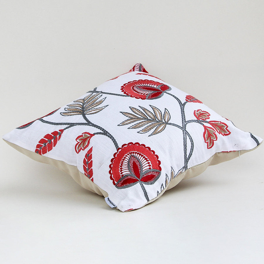 Soft cotton cushion cover with red floral embroidery displayed at an angle offering a lively nature inspired décor style with a breathable smooth and skin friendly material finish.