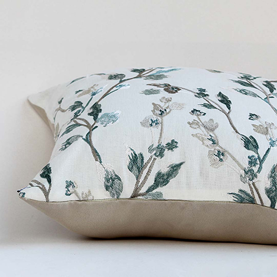 White cotton cushion cover with blue botanical foliage print for living room sofa and stylish modern home interiors.