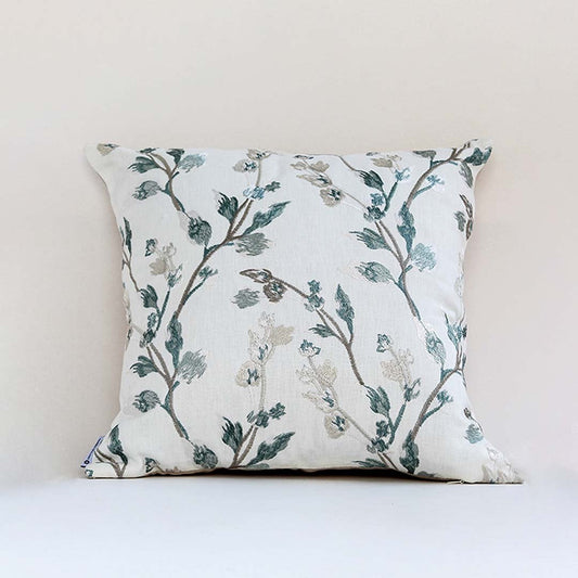 Soft white cotton cushion cover with teal botanical embroidery creating a fresh nature inspired décor accent with a breathable gentle and skin friendly material.
