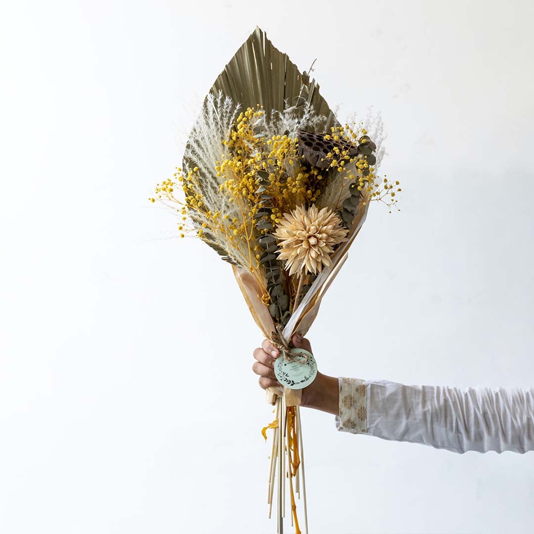 Vibrant yellow mixed dried flower bouquet on white background displaying bold color preserved texture and cheerful home decor styling.