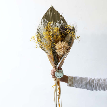 Vibrant yellow mixed dried flower bouquet on white background displaying bold color preserved texture and cheerful home decor styling.