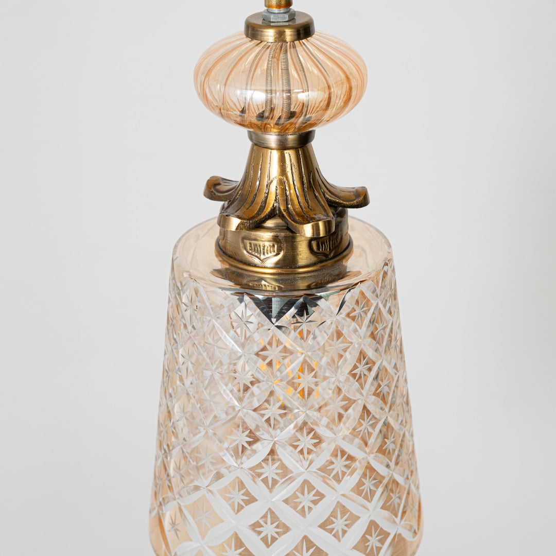 Closeup of patterned glass and gold metal pendant light showcasing intricate detailing and premium finish.