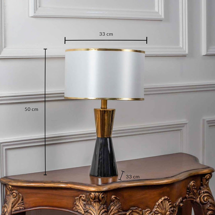 Black and gold ceramic table lamp with fabric shade shown with 50cm height and 33cm width dimensions.