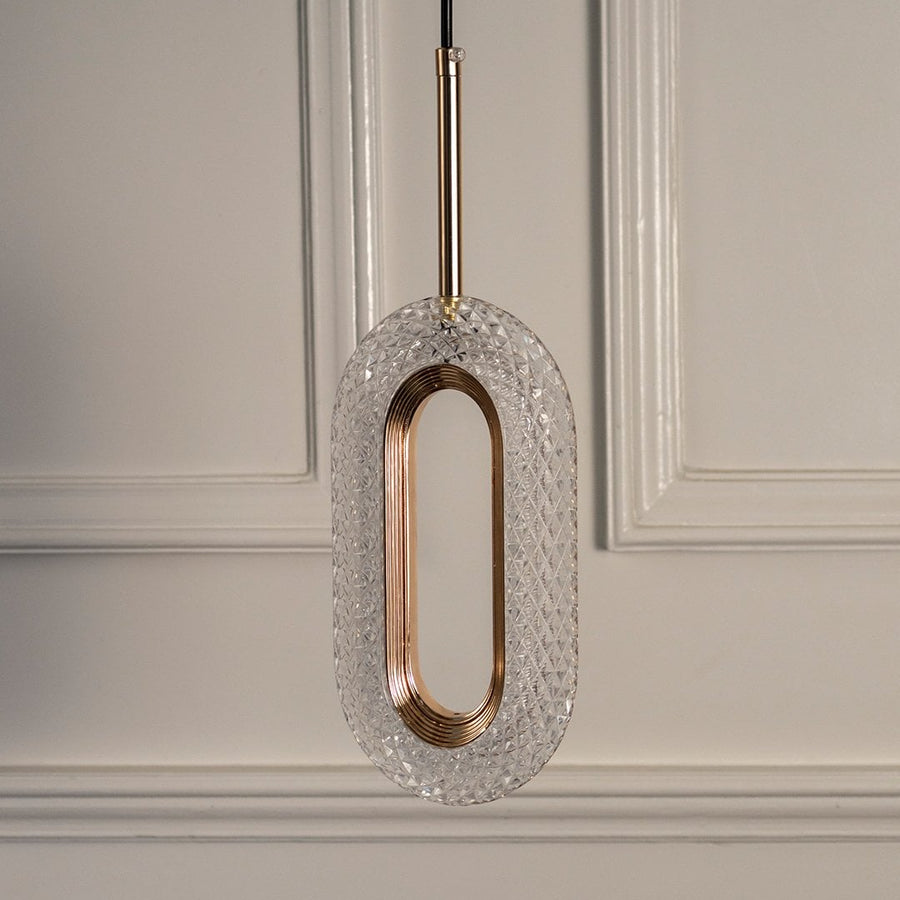Closeup of gold metal pendant light with oval frame showcasing refined finish and premium craftsmanship.