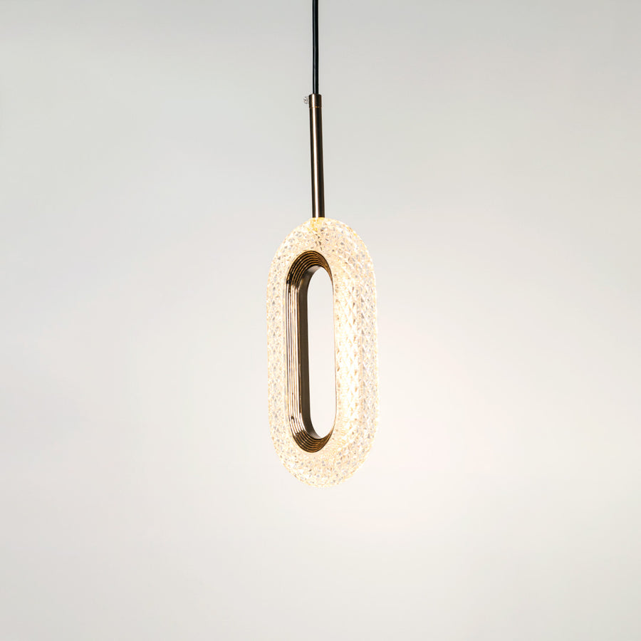Gold metal pendant light with illuminated oval design and crystal center crafted for elegant interiors.