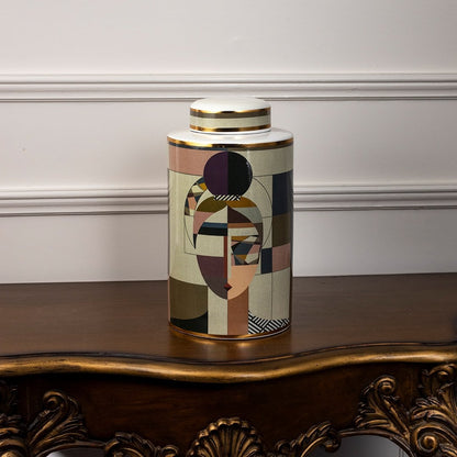 Abstract Face ceramic jar illuminated against a white background emphasizing its abstract geometric face artwork.