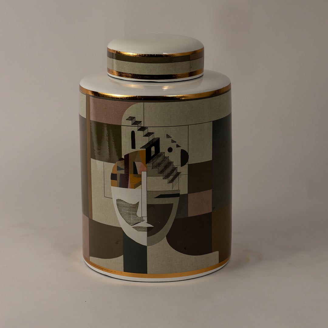 Abstract Face ceramic jar against a black background highlighting detailed geometric patterns and glossy gold trim.