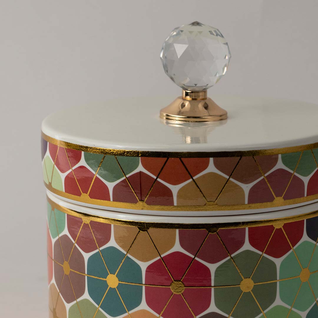 Closeup of ceramic decor jar showing detailed multicolor geometric floral artwork and glossy crystal knob top