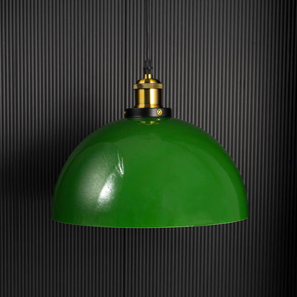 Green metal pendant light with gold holder shown unlit on black background highlighting bold color and modern ceiling lighting design.