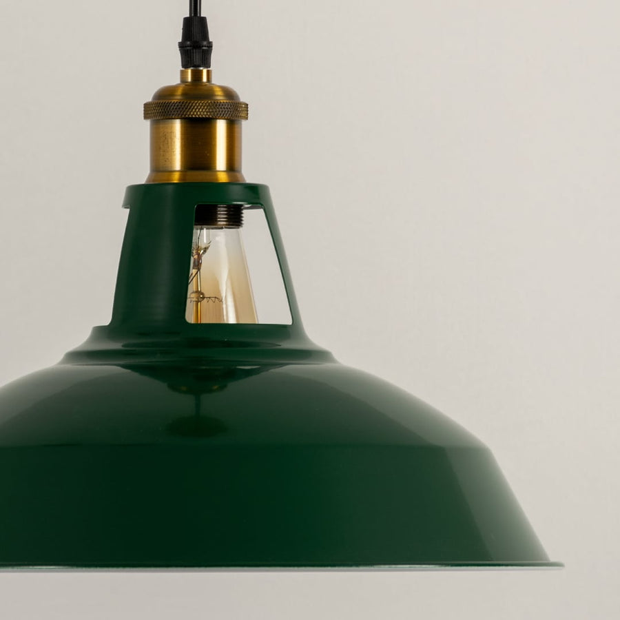 Detailed view of green metal pendant light with antique brass holder showcasing premium industrial styling.