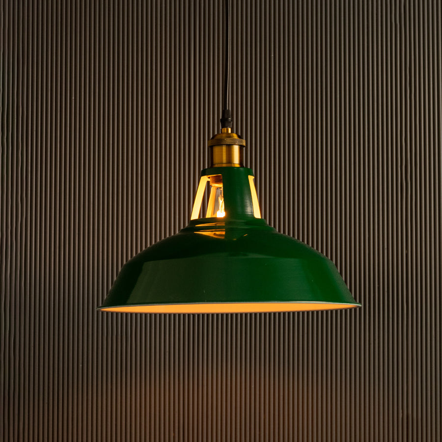 Green metal pendant light with brass accents glowing beautifully for elegant interiors.