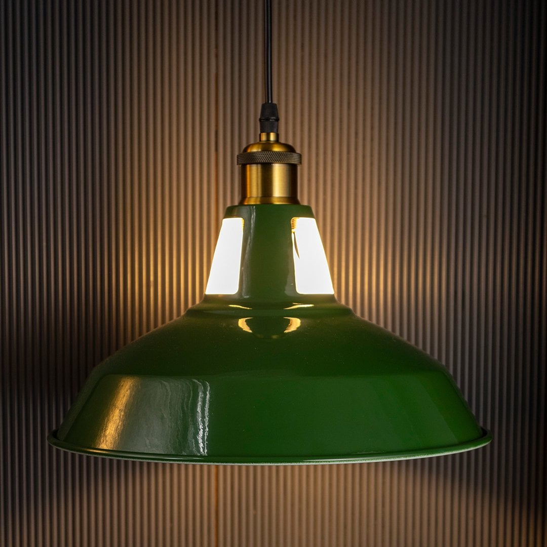 Classic green hanging pendant lamp glowing softly on black background adding warmth and charm to modern interiors.