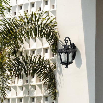 Outdoor lantern wall light illuminating a rustic brick wall adds vintage charm and warm brightness.